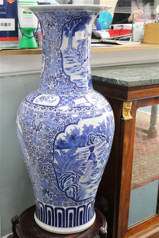 A massive Chinese blue and white vase and wood stand